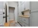 Stylish mud room with gray cabinets, wood countertop, and tiled floor at 5760 Winding Lakes Dr, Cumming, GA 30028