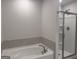 Bathroom with a soaking tub and a glass-enclosed shower at 1155 Park Center Nw Cir, Austell, GA 30168