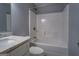 Bathroom with a tub and shower combination, marble countertop, and neutral paint at 4979 Snook Thompson Se Rd, Oxford, GA 30054