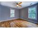Bright bedroom featuring hardwood floors, neutral paint, and a view of the property at 4979 Snook Thompson Se Rd, Oxford, GA 30054