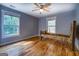 Neutral bedroom with hardwood floors, rustic wood bed frame, and view of the property at 4979 Snook Thompson Se Rd, Oxford, GA 30054
