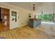 Back porch with wood floors, ceiling fans, built-in bar area, and wooded backyard views at 4979 Snook Thompson Se Rd, Oxford, GA 30054