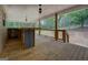 Back porch with wood floors, metal railing, ceiling fans, and wooded backyard views at 4979 Snook Thompson Se Rd, Oxford, GA 30054