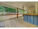 Long back porch with wood floors, ceiling fans, a built-in bar, and wooded backyard views at 4979 Snook Thompson Se Rd, Oxford, GA 30054