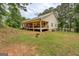 Exterior view of house featuring a porch and backyard with trees at 4979 Snook Thompson Se Rd, Oxford, GA 30054