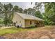 Exterior view of house featuring a covered porch and attached garage at 4979 Snook Thompson Se Rd, Oxford, GA 30054
