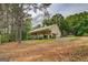 Exterior view of house featuring a covered porch and shed at 4979 Snook Thompson Se Rd, Oxford, GA 30054