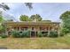 Charming ranch home featuring a wraparound porch, stone accents, and landscaped front yard at 4979 Snook Thompson Se Rd, Oxford, GA 30054