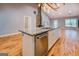 Bright kitchen with an island, granite counters, stainless steel appliances, and view of living area at 4979 Snook Thompson Se Rd, Oxford, GA 30054