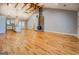 Spacious living room featuring hardwood floors, vaulted ceilings, and exposed wood beams and a fireplace at 4979 Snook Thompson Se Rd, Oxford, GA 30054