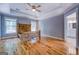 Main bedroom with hardwood floors, tray ceiling, and a view of the ensuite bathroom at 4979 Snook Thompson Se Rd, Oxford, GA 30054