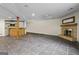 Finished basement with tile flooring, fireplace, and a built-in bar area for entertaining at 3863 Dundee Ne Dr, Roswell, GA 30075