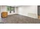 Spacious unfinished basement with tile flooring and large window for natural light at 3863 Dundee Ne Dr, Roswell, GA 30075