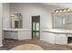 Spacious bathroom featuring dual sinks, gold accented mirrors, and unique flooring at 3863 Dundee Ne Dr, Roswell, GA 30075