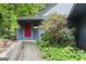 Inviting home entrance featuring a red front door and lush landscaping at 3863 Dundee Ne Dr, Roswell, GA 30075