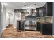 Gourmet kitchen featuring stainless steel appliances, stone backsplash and dark cabinetry at 3863 Dundee Ne Dr, Roswell, GA 30075