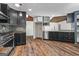Modern kitchen featuring dark cabinets, stainless steel appliances, and a stylish stone backsplash at 3863 Dundee Ne Dr, Roswell, GA 30075
