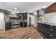 Eat-in kitchen with stainless appliances, stone accents, and black cabinetry at 3863 Dundee Ne Dr, Roswell, GA 30075