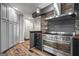 Well-equipped kitchen with stainless steel range, stone backsplash, and dark cabinets at 3863 Dundee Ne Dr, Roswell, GA 30075
