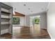 Bright living room with wood floors, recessed lighting and french doors to the sunroom at 3863 Dundee Ne Dr, Roswell, GA 30075