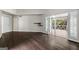 Sun-filled living room with hardwood floors and French doors to a sunroom at 3863 Dundee Ne Dr, Roswell, GA 30075