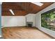 Large living room features wood ceiling, fireplace, skylights and scenic views of the backyard at 3863 Dundee Ne Dr, Roswell, GA 30075
