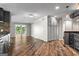 Open concept living room boasts access to a sunroom, wood floors, and built-in cabinets at 3863 Dundee Ne Dr, Roswell, GA 30075