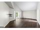 Bright open living room featuring hardwood floors and doors to a sunroom at 3863 Dundee Ne Dr, Roswell, GA 30075