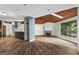 Open-concept living room with hardwood floors, stone fireplace, and a striking wood ceiling at 3863 Dundee Ne Dr, Roswell, GA 30075