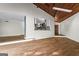 Open concept living room overlooking modern kitchen and featuring hardwood floors and wood ceiling at 3863 Dundee Ne Dr, Roswell, GA 30075