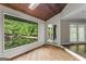 Bright living room features a wall of windows with pond view and access to another room at 3863 Dundee Ne Dr, Roswell, GA 30075