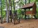 ' playground with stairs, slides, rope bridge, and a covered tree-house at 3863 Dundee Ne Dr, Roswell, GA 30075