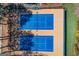 Aerial view of well-maintained tennis courts surrounded by greenery, offering recreational opportunities at 3863 Dundee Ne Dr, Roswell, GA 30075