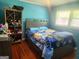 Bedroom with a large window, wood floors, and ample storage at 3969 W Hilda Cir, Decatur, GA 30035