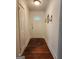 Inviting front hallway with hardwood floors and decorative light fixtures, with a white front door featuring a decorative window at 3969 W Hilda Cir, Decatur, GA 30035