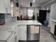Bright kitchen featuring stainless steel appliances, marble countertops, white cabinetry, and views into adjacent rooms at 3969 W Hilda Cir, Decatur, GA 30035
