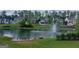 Scenic view of homes surrounding a pond with a fountain and lush green landscaping at 101 Eadestowne Way, Peachtree City, GA 30269