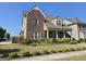 Lovely brick home with manicured landscaping and a welcoming covered porch at 101 Eadestowne Way, Peachtree City, GA 30269
