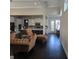 Open-concept living room with hardwood floors and view of the modern kitchen at 101 Eadestowne Way, Peachtree City, GA 30269