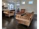 Cozy living room featuring hardwood floors and stylish brown tufted furniture at 101 Eadestowne Way, Peachtree City, GA 30269