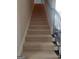 Carpeted staircase with dark metal railing leads to the upper level at 101 Eadestowne Way, Peachtree City, GA 30269