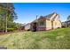 Backyard of house with grass lawn and mature trees at 237 Highcrest Dr, Acworth, GA 30101