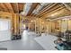 Unfinished basement with exposed beams, lighting and door to outside at 237 Highcrest Dr, Acworth, GA 30101