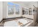 Bright bathroom featuring a soaking tub with tile surround and a large window at 237 Highcrest Dr, Acworth, GA 30101