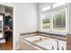 Bathroom with a large soaking tub and walk-in closet access at 237 Highcrest Dr, Acworth, GA 30101