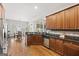 Bright kitchen with stainless appliances, stone backsplash, wood cabinets, and a view of the dining area at 237 Highcrest Dr, Acworth, GA 30101