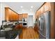 Well-lit kitchen with stainless steel appliances, hardwood floors, and wooden cabinets at 237 Highcrest Dr, Acworth, GA 30101