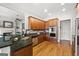 Open kitchen featuring stainless steel appliances, wood floors, and granite countertops at 237 Highcrest Dr, Acworth, GA 30101