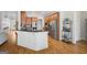 Spacious kitchen with wood floors, center island, stainless appliances, and dark granite countertops at 237 Highcrest Dr, Acworth, GA 30101
