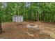 View of backyard featuring a shed and firepit, perfect for outdoor entertaining at 372 River Point Dr, Mcdonough, GA 30252